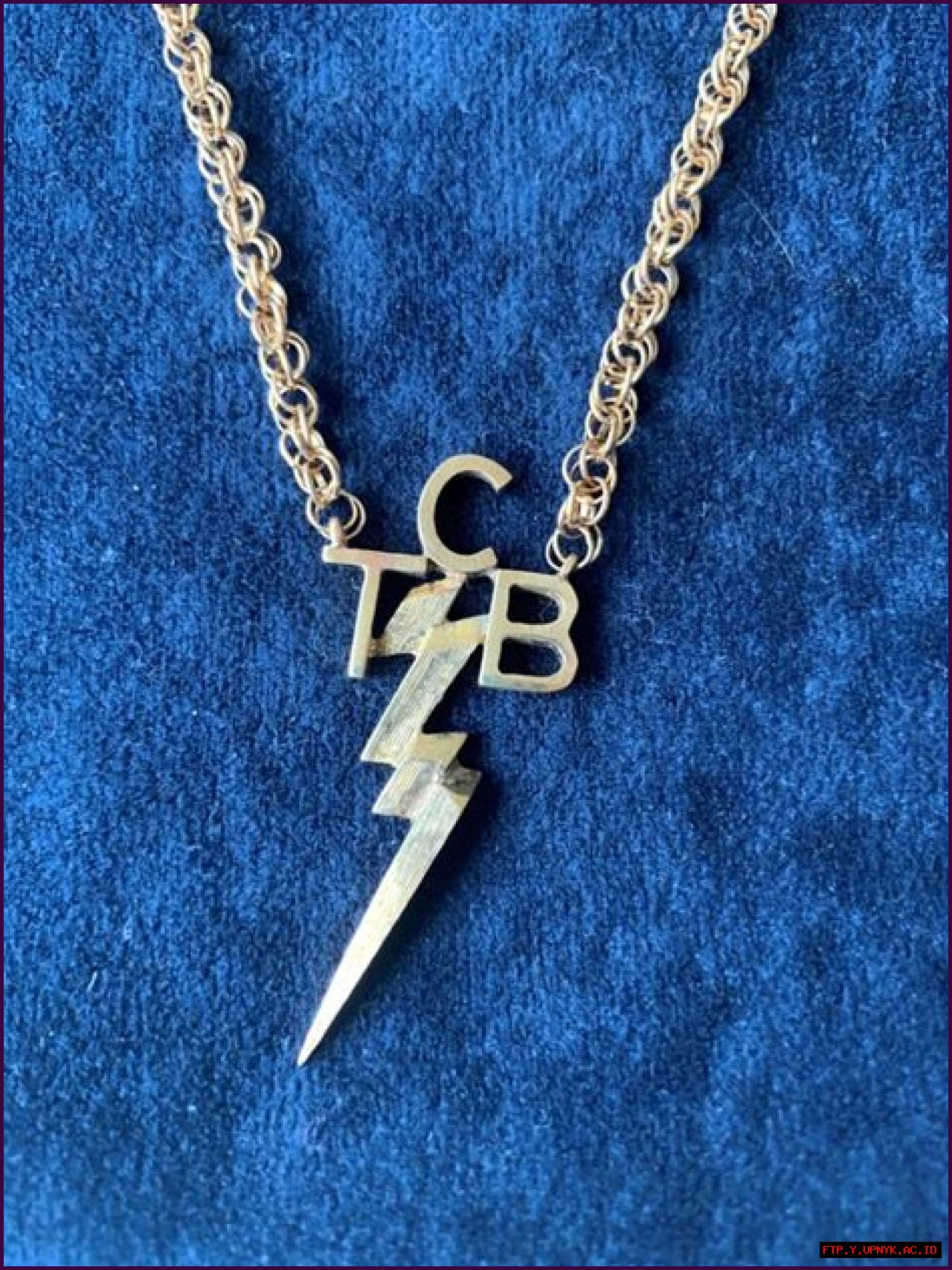 A King's Adornment: Elvis In His Iconic TCB Necklace